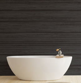 Black wooden effect wallpaper with rich grain texture creating a bold and cozy atmosphere in a modern bedroom.
