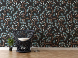 Trendy apartment living space accent wall wallpaper with dark floral vine and blue leaf highlights