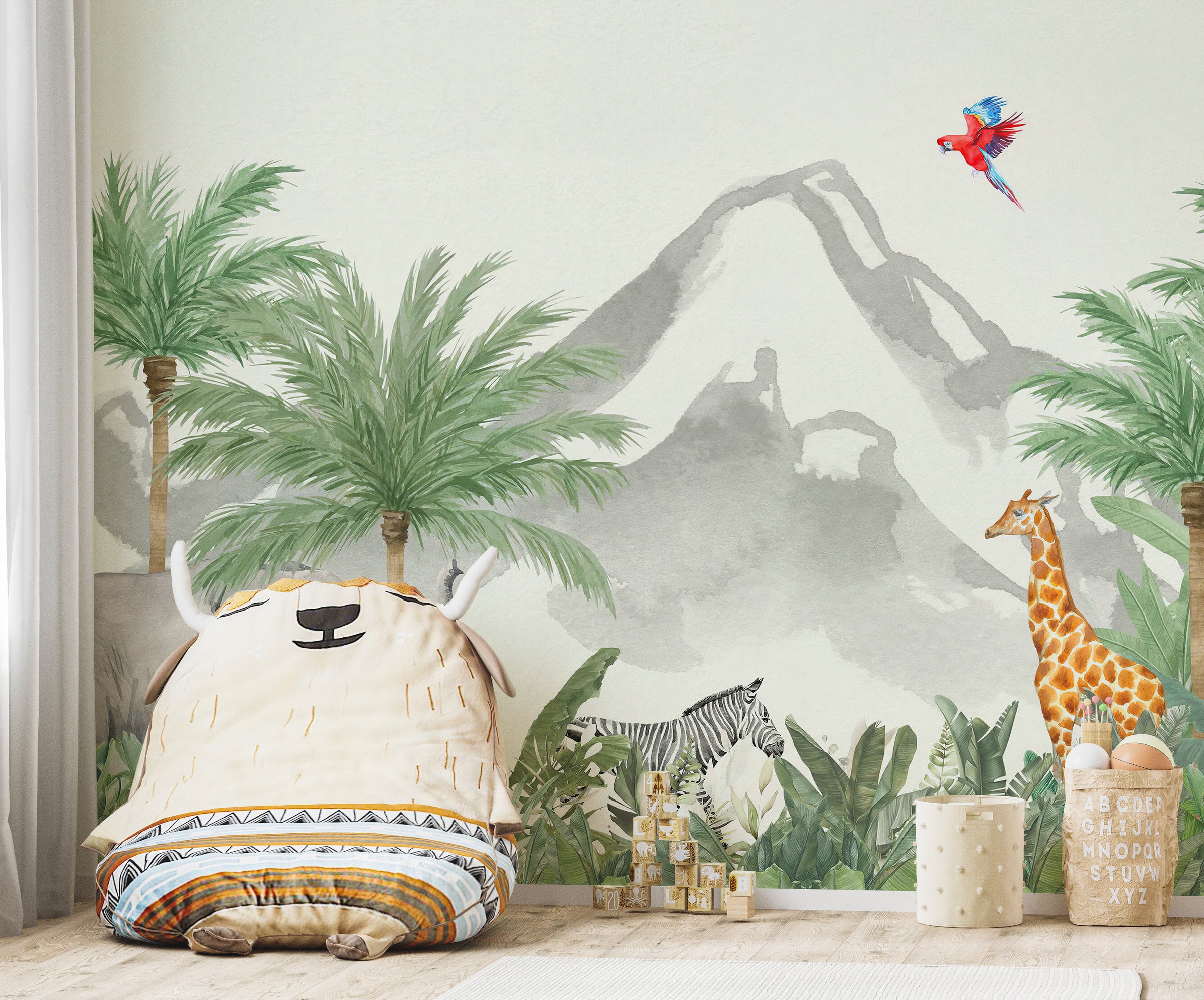Children's room with a mountain and palm tree mural, stuffed animal.