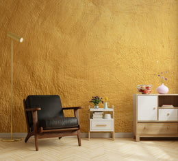 Rich ochre textured wallpaper behind black chair for minimalist home office interior design