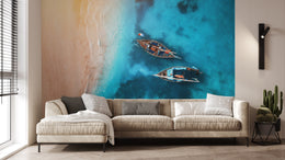 Coastal ocean boat wall mural enhancing living room with tropical resort style and calming blue tones
