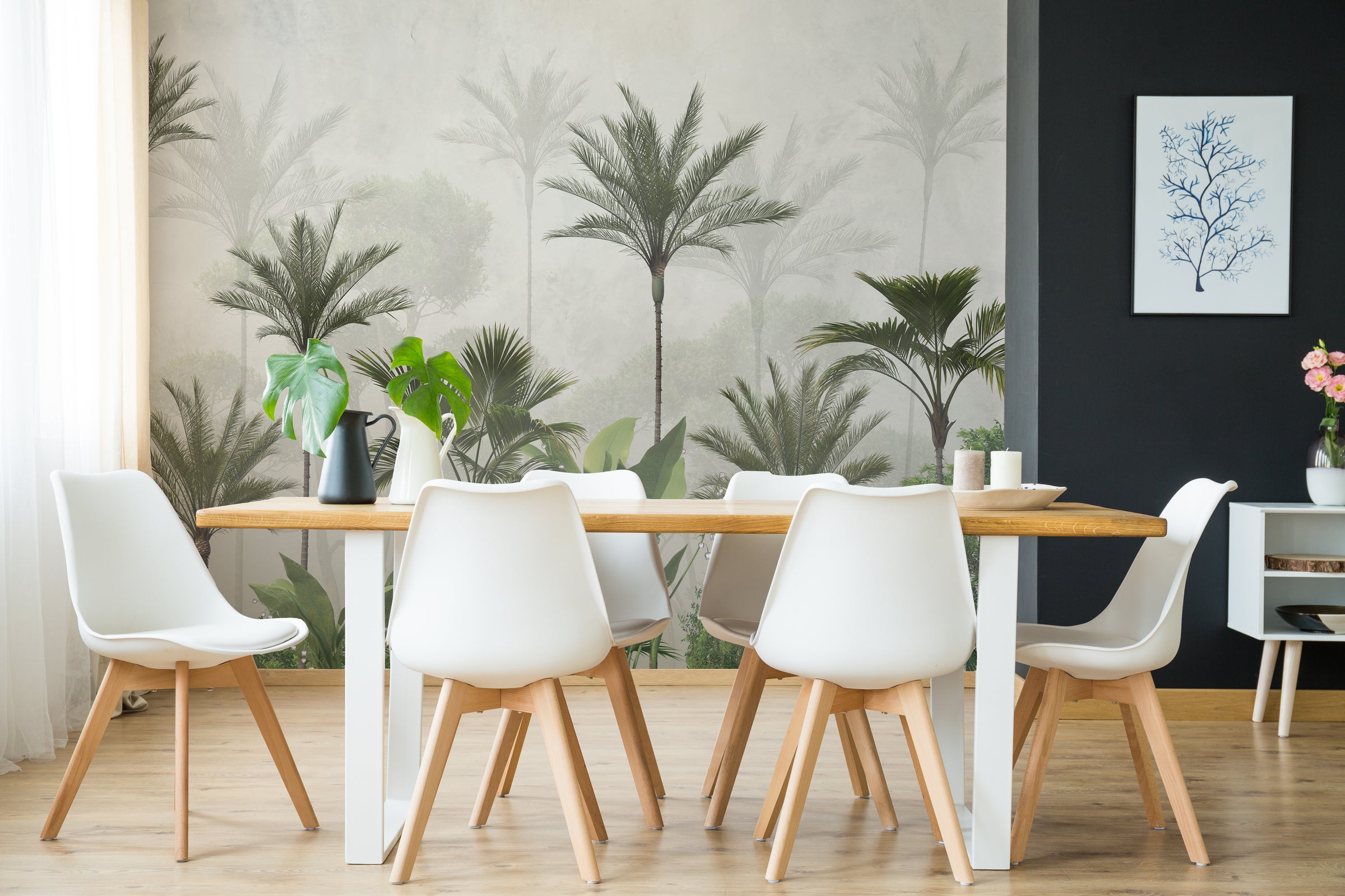 Tropical forest wall mural in subtle green hues enhancing stylish dining room ambiance