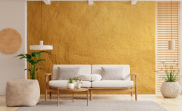 Warm rustic yellow textured wall for chic studio apartment interior with minimal decor